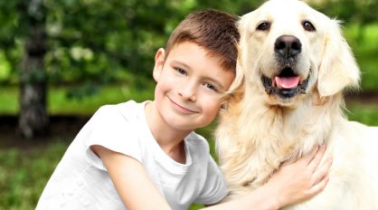 Boy Hugging Dog — Veterinary Services In Medowie, NSW